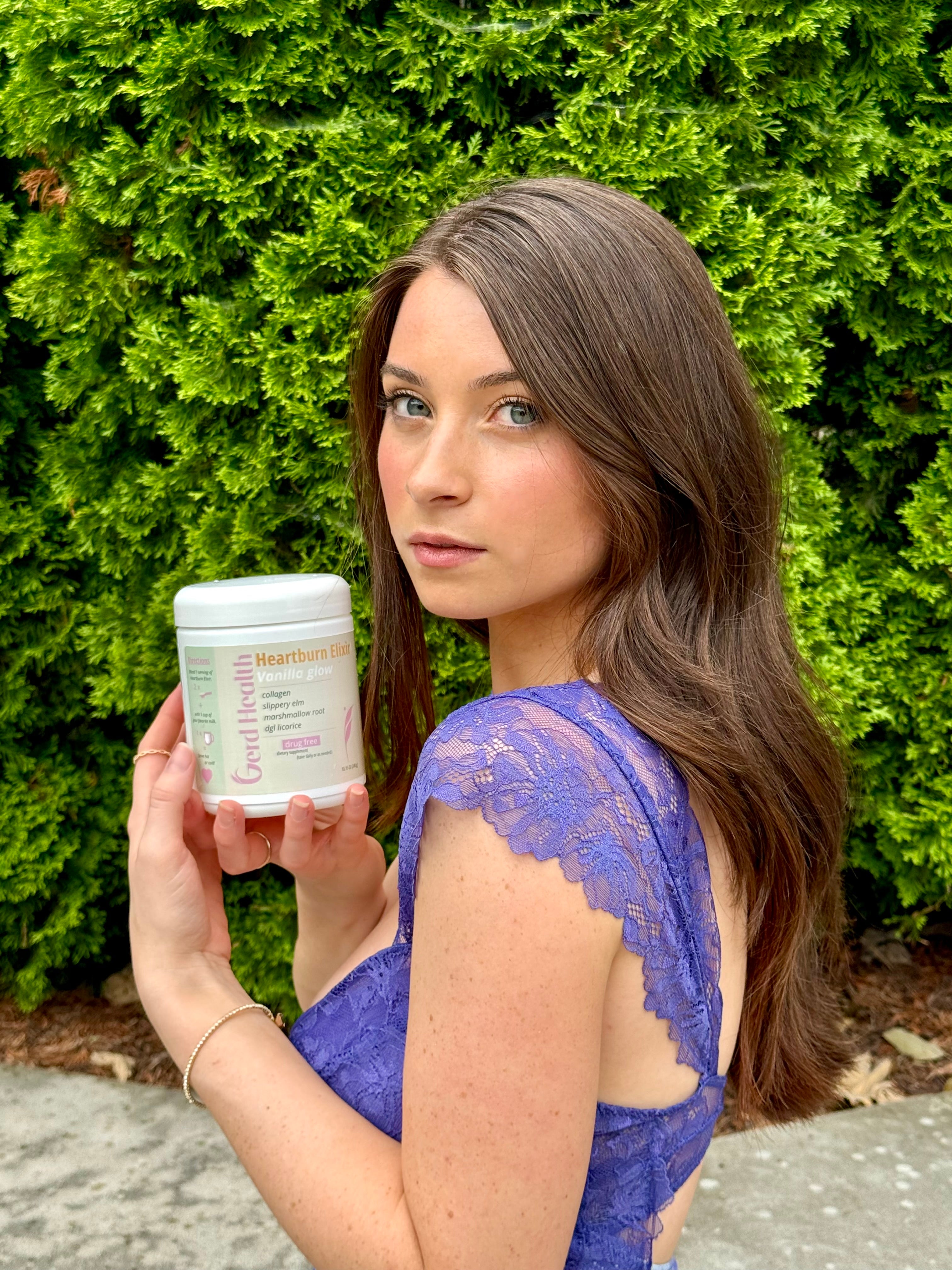 Young woman holding a Vanilla Glow heartburn elixir